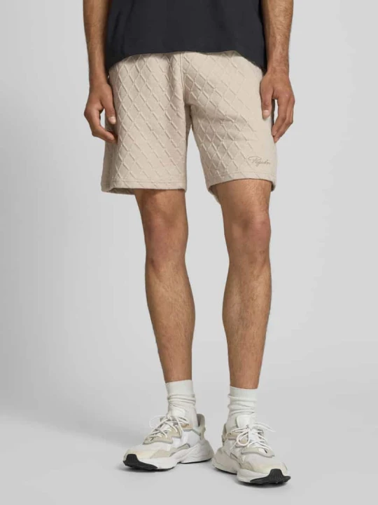 Zdjęcie produktu Szorty typu sweat o kroju relaxed fit z fakturowanym wzorem model 'Jovren' Pegador Złamany biały