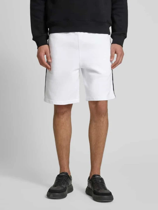 Zdjęcie produktu Szorty z dzianiny dresowej o kroju regular fit z lampasami Lacoste Biały