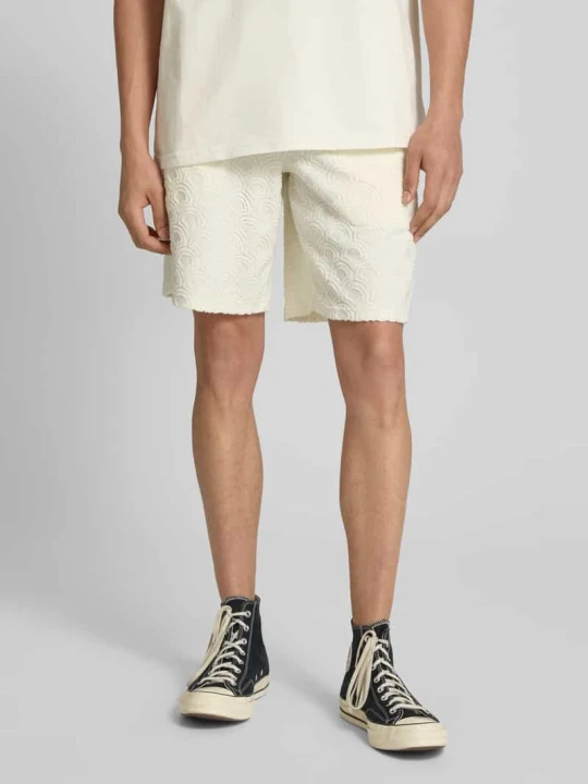 Zdjęcie produktu Szorty z dzianiny dresowej z elastycznym pasem model ‘JAIDEN’ Jack&Jones Złamany biały