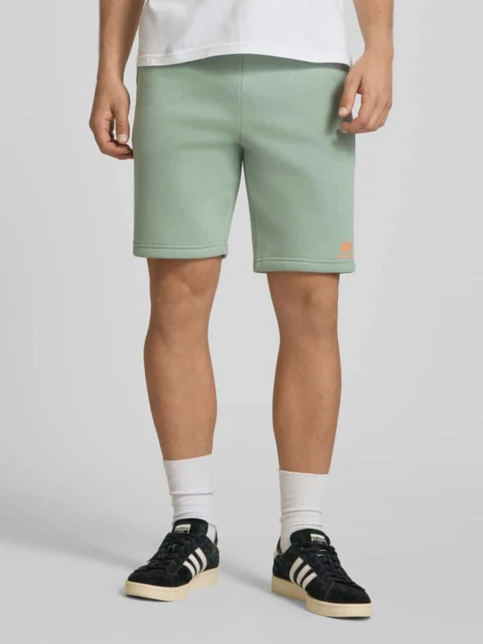 Zdjęcie produktu Szorty z wpuszczanymi kieszeniami i nadrukiem z logo Alpha Industries Limonkowy