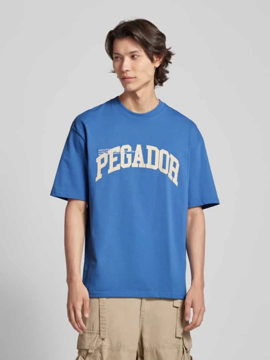 Zdjęcie produktu T-shirt o kroju oversized z nadrukiem z logo model ‘GILFORD’ Pegador Niebieski