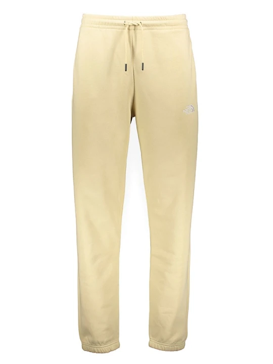 Zdjęcie produktu The North Face Spodnie dresowe "Essentials" w kolorze kremowym rozmiar: XL