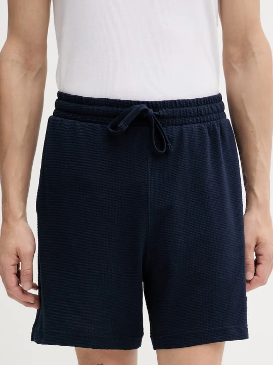 Zdjęcie produktu Tommy Jeans szorty dresowe męskie z bawełną granatowy