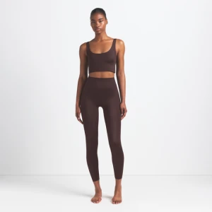 Legginsy damskie z wzmocnionym szwem i wysokim stanem 66 cm NikeSKIMS Satin Shine - Brązowy