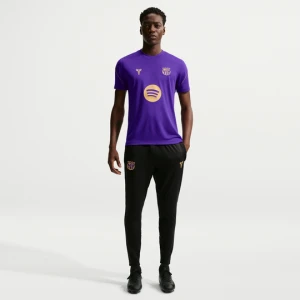 Męskie dzianinowe spodnie piłkarskie Kobe Dri-FIT FC Barcelona Strike (wersja wyjazdowa) - Czerń Nike
