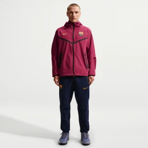 Męskie spodnie piłkarskie z tkaniny Nike F.C. Barcelona Tech - Niebieski