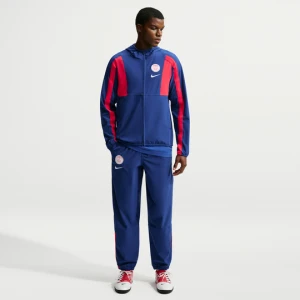 Męskie spodnie piłkarskie z tkaniny Nike Paris Saint-Germain Energy - Niebieski