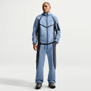Męskie spodnie z dzianiny w kontrastowych kolorach z luźnymi nogawkami Nike Tech - Niebieski