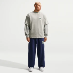 Męskie spodnie z dzianiny z luźnymi nogawkami Nike Solo Swoosh - Niebieski