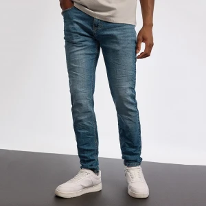Niebieskie jeansy slim fit z efektem sprania House