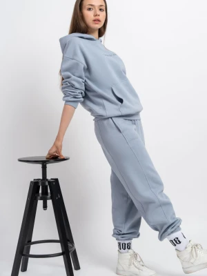 Niebieskie spodnie dresowe oversize z modnymi cięciami Reporter