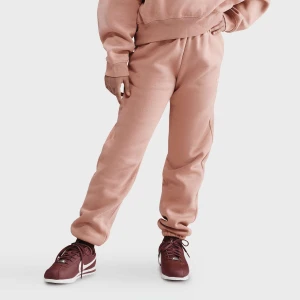 Nike G NSW TREND FLC CF PANT rose gold/washed coral uniseks Spodnie dresowe różowy rozmiar Odzież