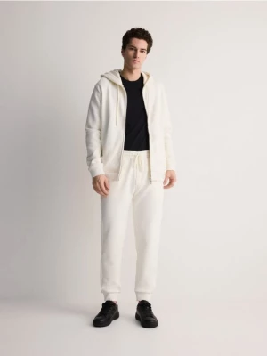 Reserved - Bawełniane spodnie dresowe - złamana biel