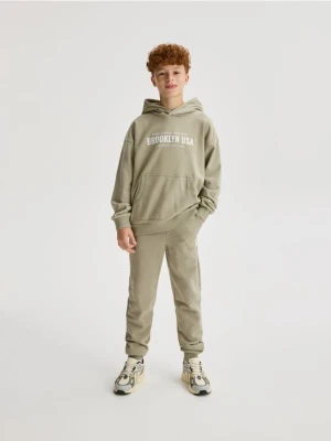 Reserved - Bawełniane spodnie jogger - jasnozielony