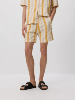 Reserved - Bawełniane szorty jogger - bursztynowy