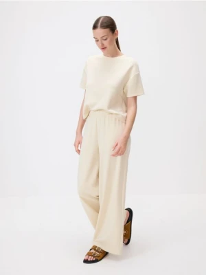 Reserved - Dresowe spodnie z modalem - jasnożółty