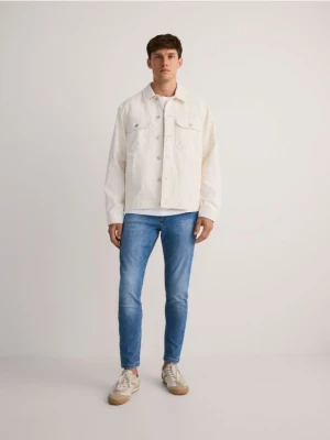 Reserved - Jeansy skinny z efektem sprania - niebieski