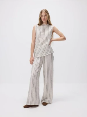 Reserved - Luźne spodnie z metalizowaną nitką - beżowy