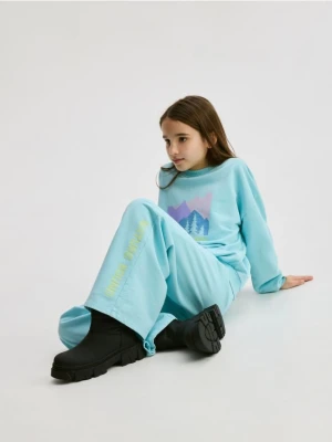 Reserved - Spodnie dresowe z nadrukiem - jasnoturkusowy