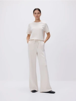 Reserved - Spodnie z szeroką nogawką - beżowy