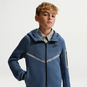 Rozpinana bluza z kapturem i akcentami o designie odbijającym światło dla dużych dzieci Nike Tech Fleece - Niebieski