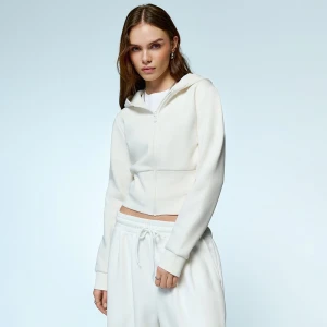 Rozpinana kremowa bluza z szerokim ściągaczem na dole House