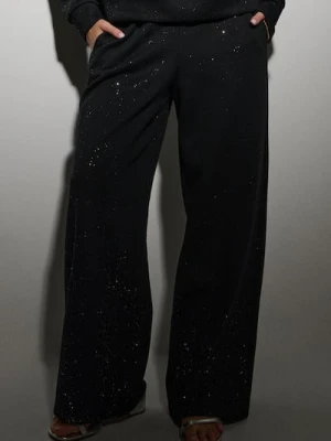 Sinsay - Dresowe spodnie z szeroką nogawką i brokatem - czarny