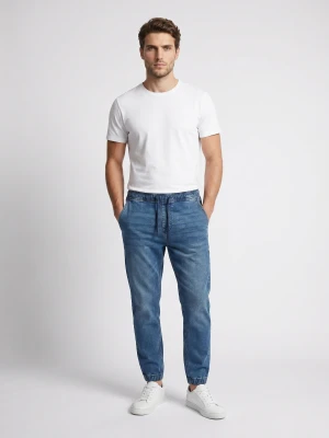 Sinsay - Jeansy jogger slim z efektem sprania - niebieski