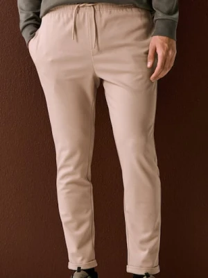 Sinsay - Spodnie dresowe jogger z domieszką wiskozy - beżowy