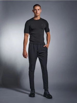 Sinsay - Spodnie dresowe SNSY PERFORMANCE - czarny