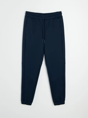 Sinsay - Spodnie tapered fit Active - granatowy