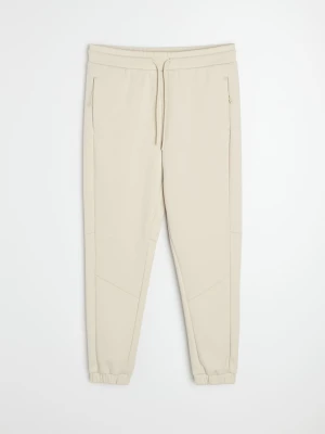 Sinsay - Spodnie tapered fit Active - kremowy