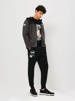 Sinsay - Spodnie tapered fit NASA - czarny