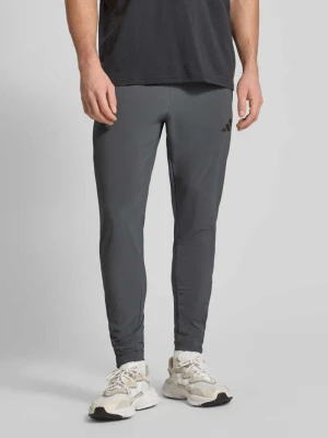 Spodnie dresowe o kroju regular fit z elastycznym pasem model 'TIRO' adidas Sportswear