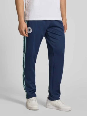 Spodnie dresowe o kroju regular fit z klubową aplikacją z logo model 'BLNACO' adidas Originals