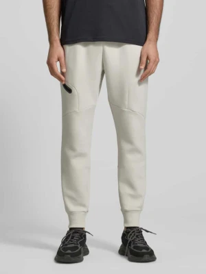 Spodnie dresowe o kroju regular fit z nadrukiem logo model ‘Unstoppable’ Under Armour