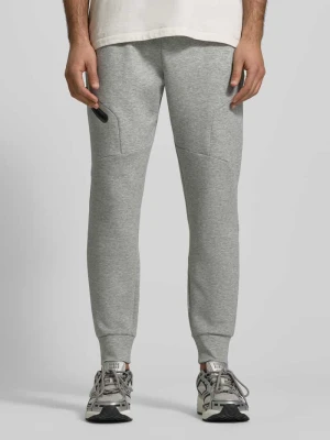 Spodnie dresowe o kroju regular fit z nadrukiem logo model ‘Unstoppable’ Under Armour