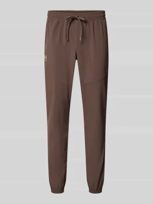Spodnie dresowe o kroju relaxed fit z nadrukiem z logo Under Armour Błotnisty