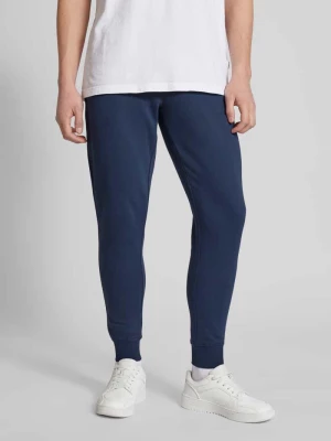 Spodnie dresowe o kroju slim fit z efektem melanżowym Tommy Jeans