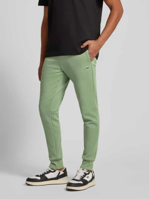 Spodnie dresowe o kroju slim fit z mieszanki bawełny Lacoste