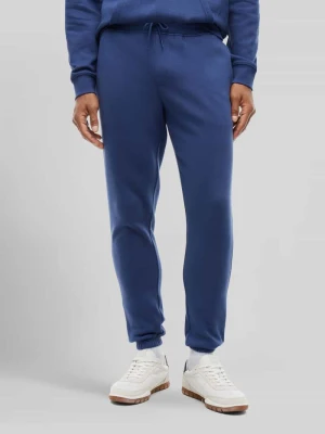 Spodnie dresowe o kroju slim fit z mieszanki bawełny Tommy Jeans Ciemnoniebieski