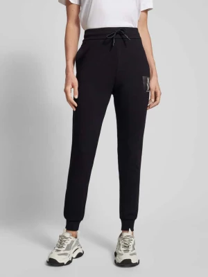 Spodnie dresowe o kroju slim fit z nadrukiem z logo Armani Exchange