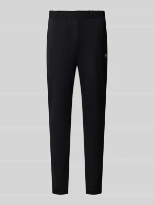 Spodnie dresowe o kroju slim fit z naszywką z logo Lacoste Czarny