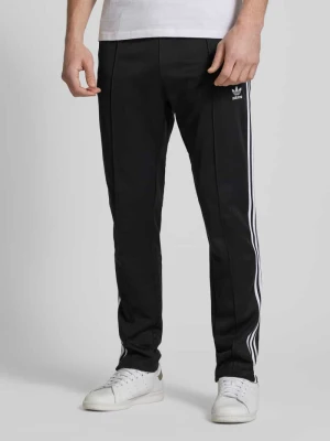 Spodnie dresowe o kroju slim fit z wyhaftowanym logo model ‘BECKENBAUER’ adidas Originals
