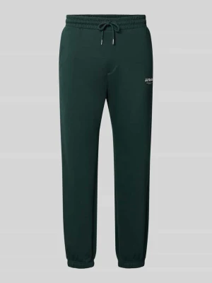 Spodnie dresowe o kroju straight fit z mieszanki bawełny model 'Kane' Jack&Jones Ciemnozielony