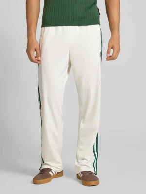 Spodnie dresowe o rozkloszowanym kroju z elastycznym pasem model ‘FIREBIRD’ adidas Originals