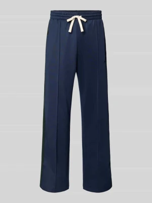 Spodnie dresowe z kieszeniami zapinanymi na zamek błyskawiczny i trokiem ANOTHER COTTON LAB