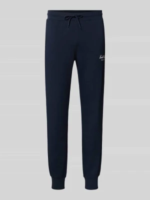 Spodnie dresowe z nadrukiem z logo model 'GORDON' Jack&Jones Ciemnoniebieski