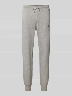 Spodnie dresowe z nadrukiem z logo model 'GORDON' Jack&Jones Jasnoszary melanż