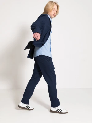 Spodnie garniturowe w drobną grantowo-czarną kratkę Reporter